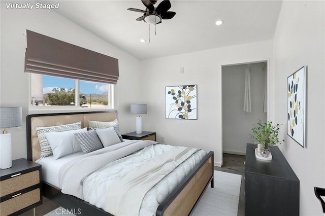 bedroom with wood-type flooring, vaulted ceiling, and ceiling fan