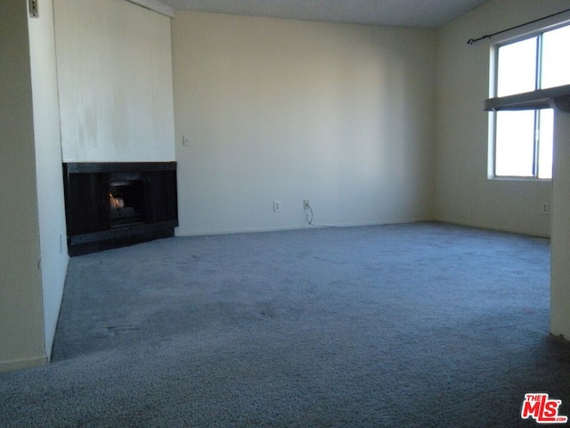 unfurnished living room with carpet