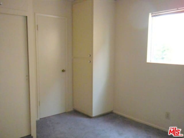 unfurnished bedroom featuring carpet flooring