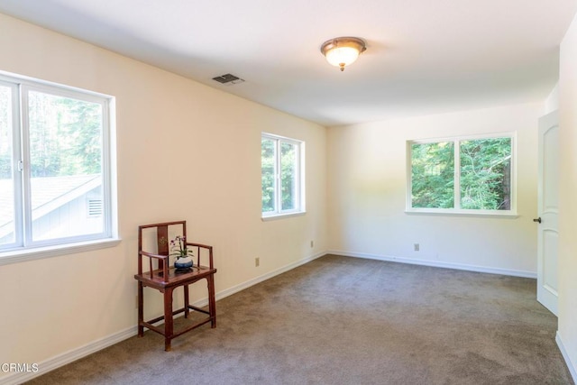 unfurnished room with carpet, baseboards, and visible vents
