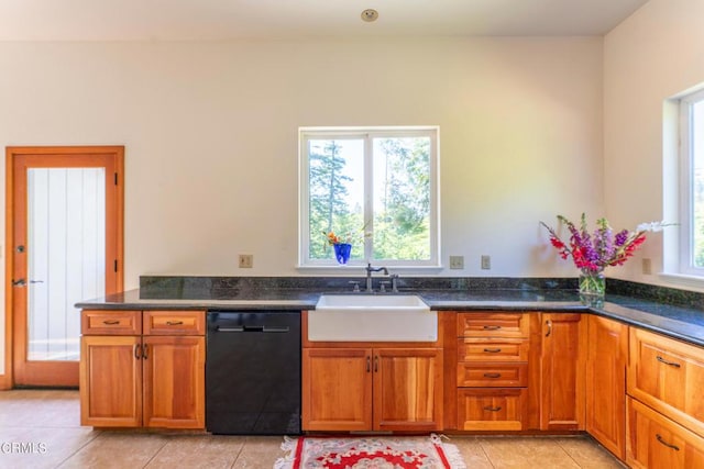 kitchen with black dishwasher, brown cabinetry, a sink, and a healthy amount of sunlight