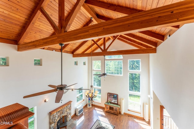 living room featuring high vaulted ceiling, light hardwood / wood-style flooring, and a wealth of natural light