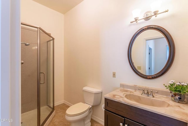 full bath featuring tile patterned flooring, vanity, toilet, baseboards, and a stall shower