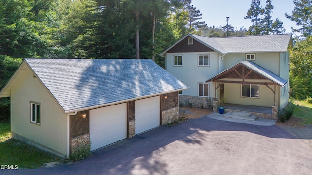 view of front of property with covered porch and a garage