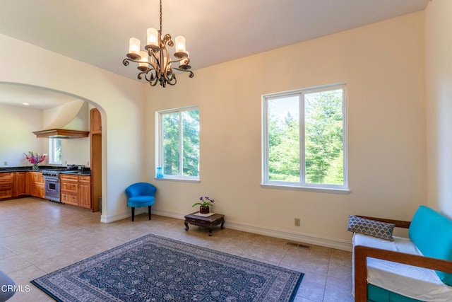 interior space with dark stone countertops, dishwasher, sink, and a healthy amount of sunlight