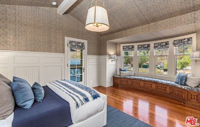 bedroom featuring vaulted ceiling with beams and hardwood / wood-style floors