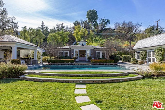 view of swimming pool featuring a lawn and a gazebo