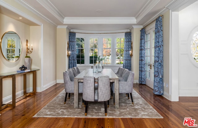 dining area featuring a tray ceiling, dark hardwood / wood-style floors, and crown molding