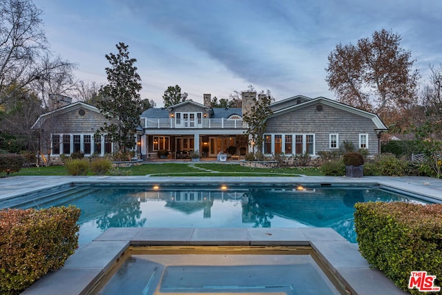 view of pool featuring a lawn and a patio