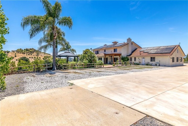 view of front of property featuring solar panels