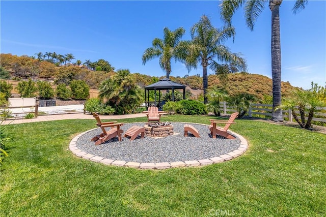 view of yard with a gazebo and a fire pit