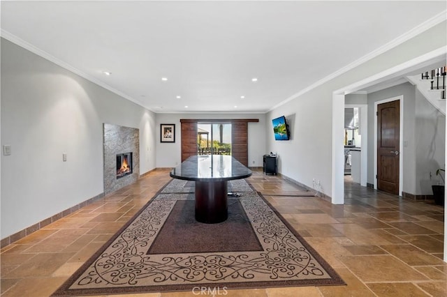 dining room with crown molding and a high end fireplace