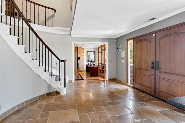 entrance foyer featuring ornamental molding