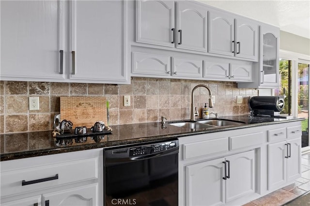 kitchen featuring sink, white cabinets, dark stone counters, and black dishwasher