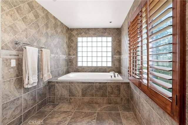 bathroom featuring tile walls and tiled tub