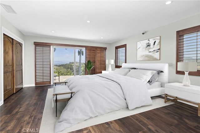 bedroom featuring access to exterior and dark hardwood / wood-style floors