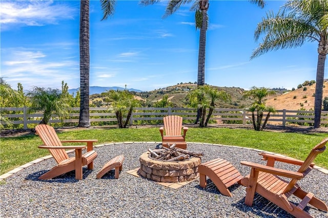 view of patio / terrace featuring a fire pit and a mountain view