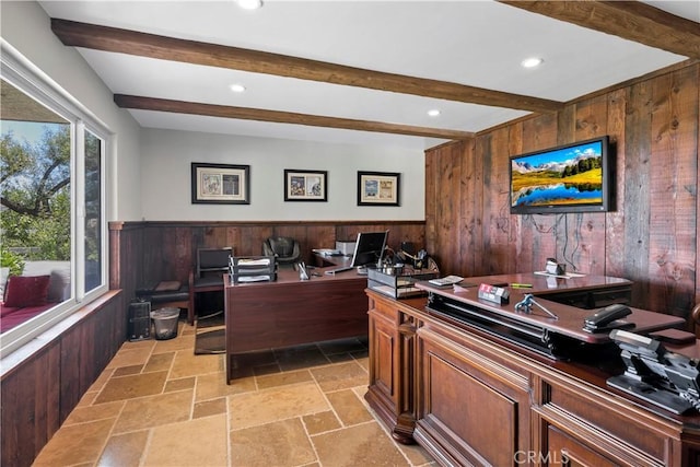 office area with wood walls and beamed ceiling