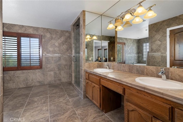 bathroom featuring vanity, tile patterned floors, walk in shower, and tile walls