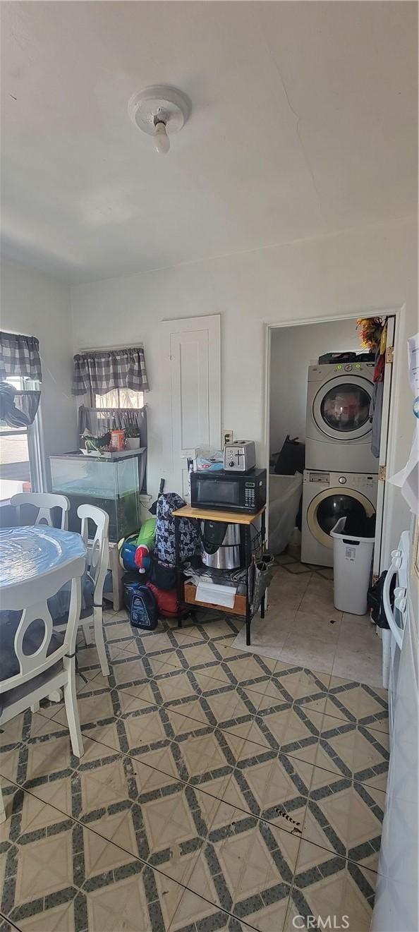 1348 E 21st St, Los Angeles, CA 90011 - clothes washing area with estacked washer and dryer and light tile patterned floors