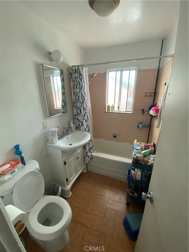 full bathroom with shower / tub combo, vanity, toilet, and parquet floors