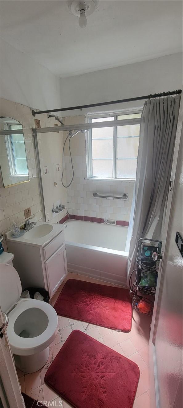 1348 E 21st St, Los Angeles, CA 90011 - bathroom featuring tile patterned floors, shower / tub combo with curtain, vanity, and toilet