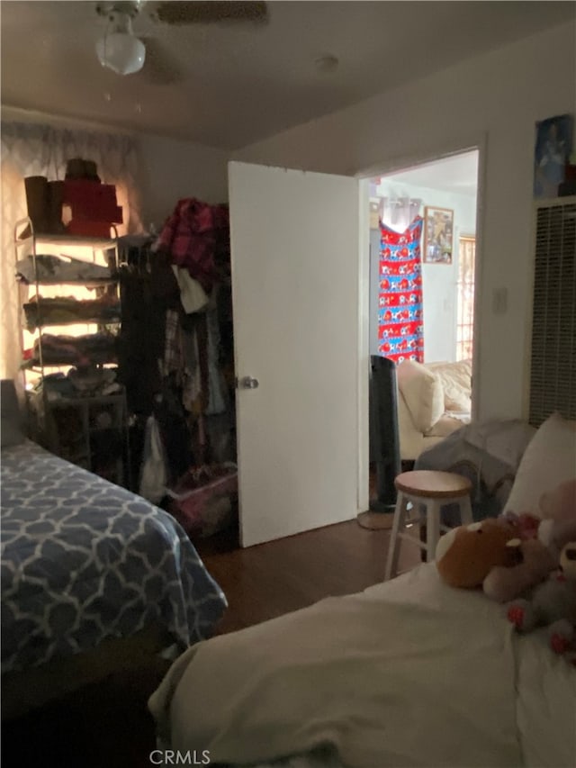 bedroom featuring ceiling fan and dark hardwood / wood-style floors