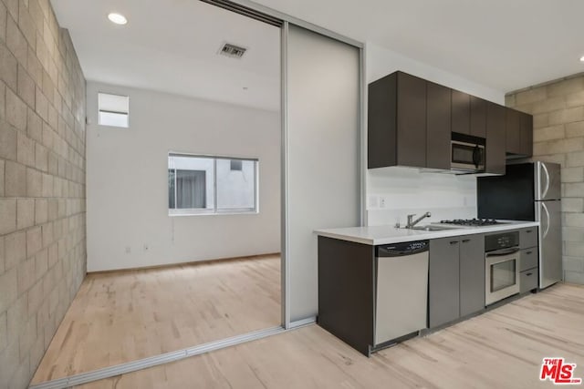 kitchen featuring sink, light hardwood / wood-style floors, and appliances with stainless steel finishes