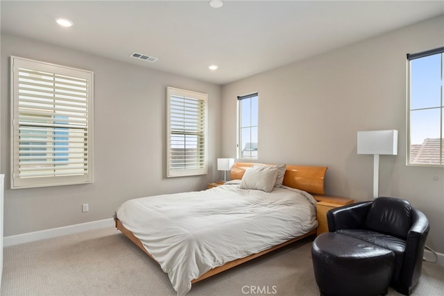 carpeted bedroom featuring multiple windows