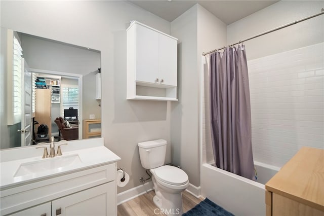 full bathroom featuring vanity, toilet, hardwood / wood-style flooring, and shower / tub combo with curtain