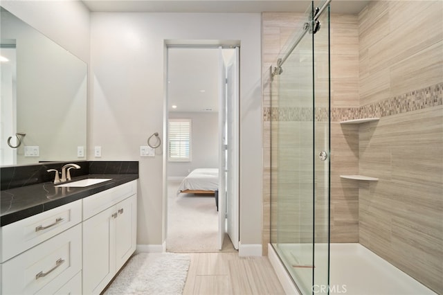 bathroom featuring vanity, an enclosed shower, and tile patterned floors