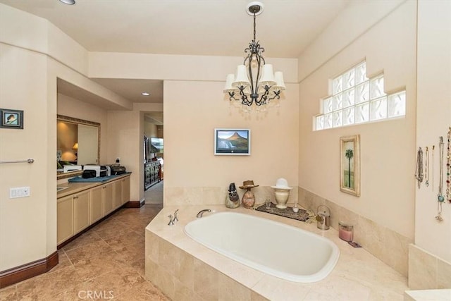 bathroom with a garden tub and a chandelier