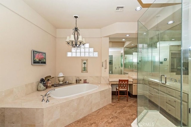 bathroom featuring vanity, visible vents, a stall shower, a garden tub, and a notable chandelier