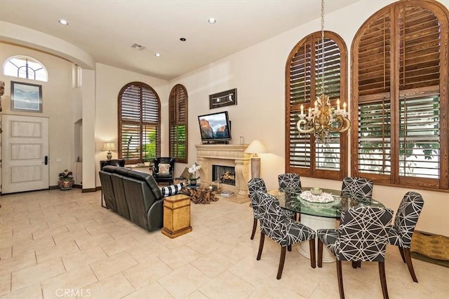 tiled dining room with a chandelier