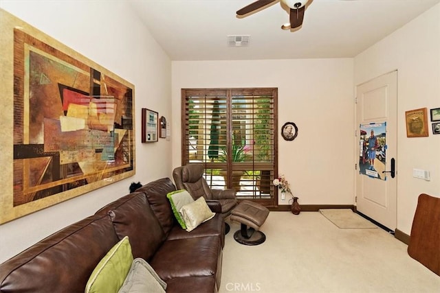 living room featuring visible vents, carpet flooring, baseboards, and ceiling fan