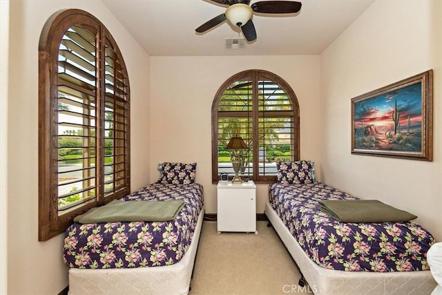 bedroom with ceiling fan and light carpet