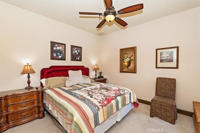 bedroom featuring ceiling fan and light colored carpet