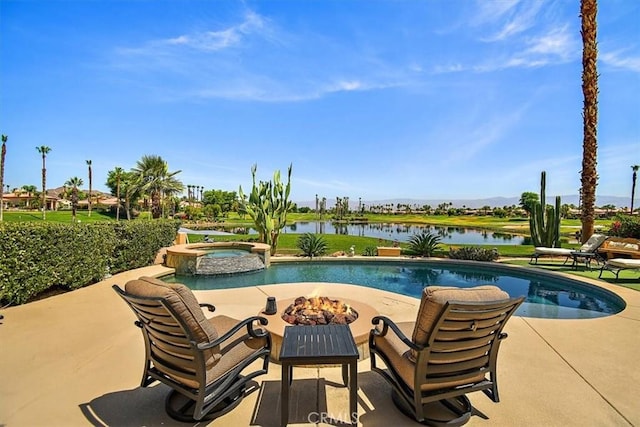 view of swimming pool featuring a patio, an outdoor fire pit, a pool with connected hot tub, and a water view