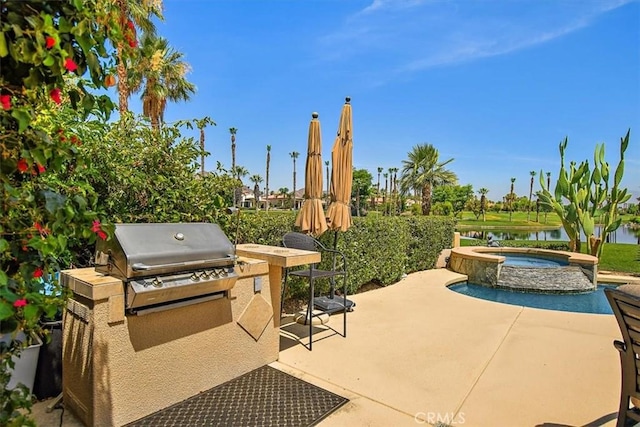 view of patio / terrace with an in ground hot tub, a water view, and grilling area