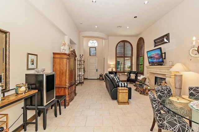 living room with recessed lighting and a fireplace with raised hearth