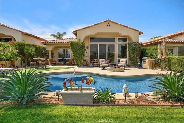 back of property with a patio area, stucco siding, an outdoor pool, and a tiled roof