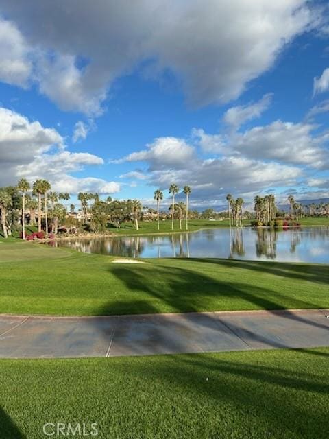 view of property's community featuring a yard and a water view