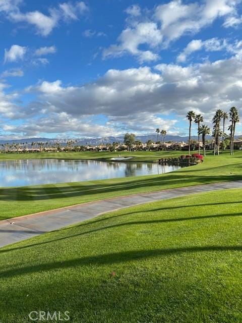 view of community featuring a water view and a lawn