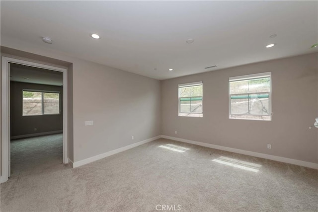 carpeted empty room with a healthy amount of sunlight