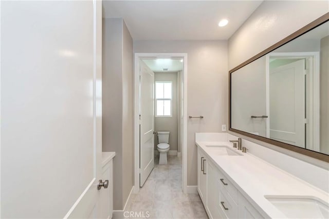 bathroom featuring tile patterned flooring, vanity, and toilet