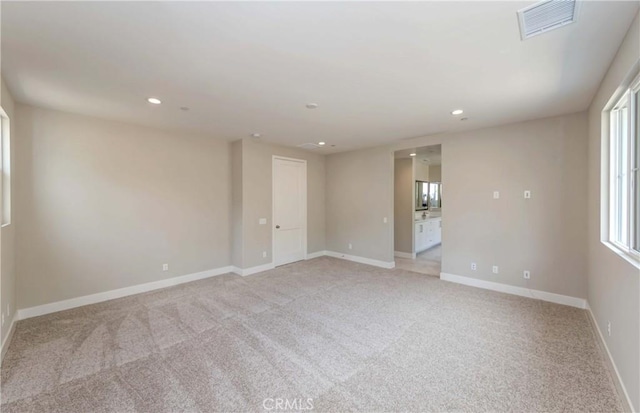 empty room featuring light carpet