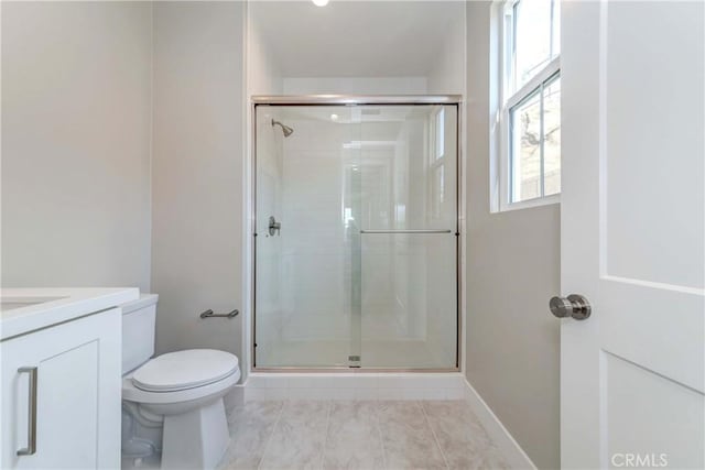 bathroom with vanity, a shower with door, tile patterned flooring, and toilet