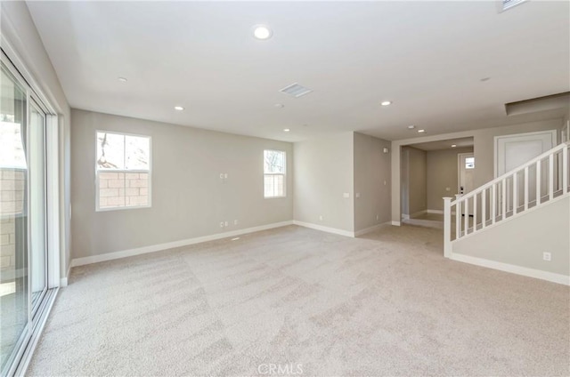 carpeted spare room with a wealth of natural light