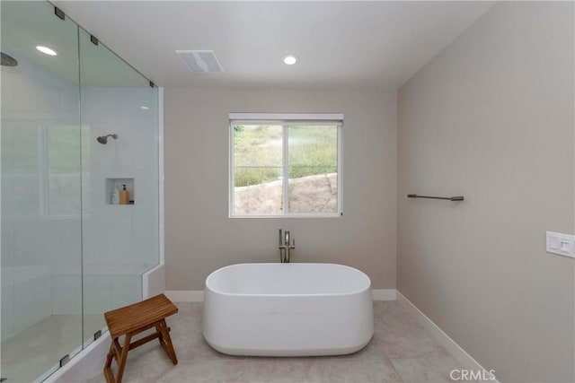 bathroom featuring tile patterned flooring and separate shower and tub