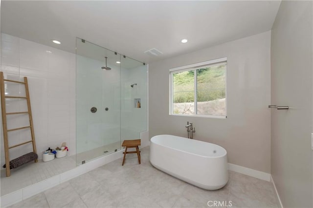 bathroom featuring tile patterned floors and independent shower and bath